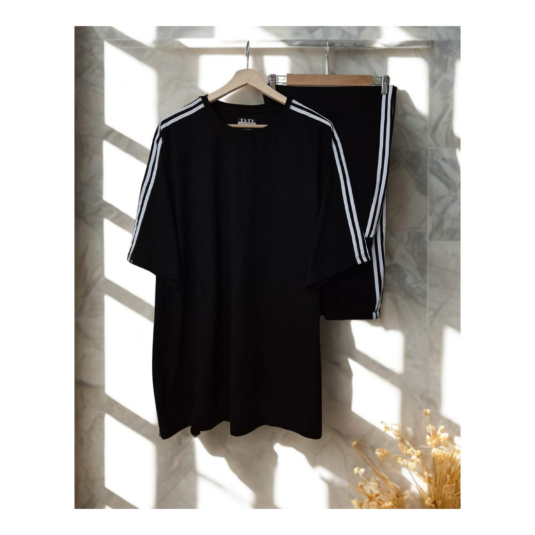 Black track-stripe cotton co-ord with white sleeve and trouser stripes for a New Year party outfit