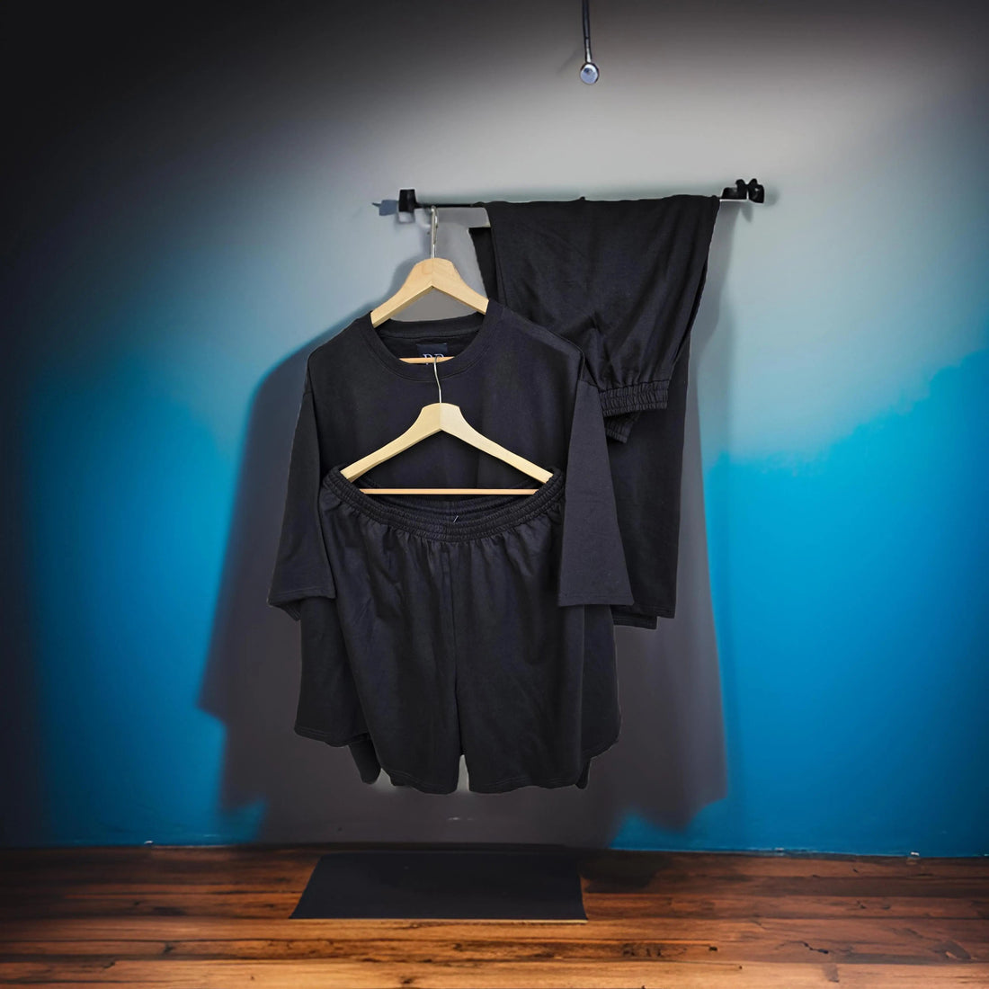 Black cotton co-ord set with matching top, shorts and joggers for a men's travel outfit guide