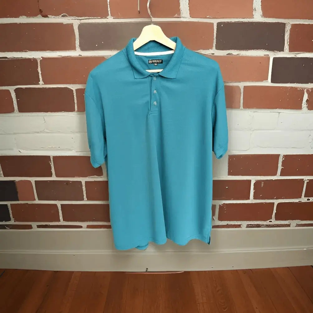 Teal blue short-sleeved polo shown full-length on a hanger, with its body hem visible
